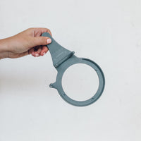 Hand holding the TM Twister, a moulded ring with a lever handle