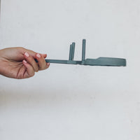 TM Twister held on its side to show its flat profile and lever