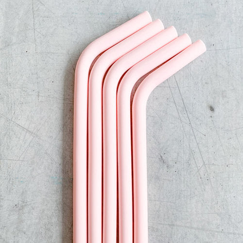 Four pink Wide Reusable Silicone Straws lined up side by side