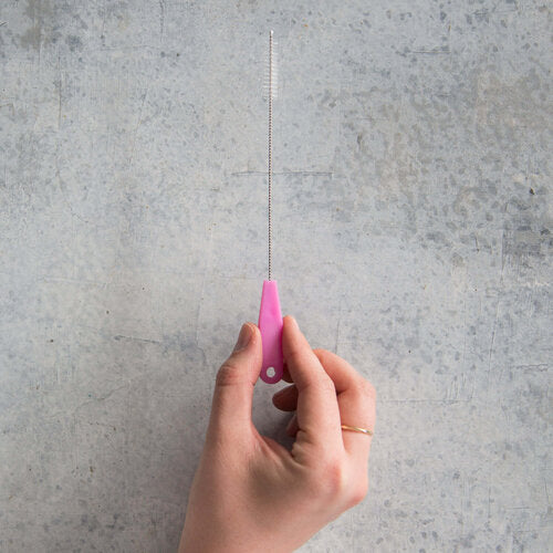 Hand holding a single pink Wide Reusable Silicone Straw