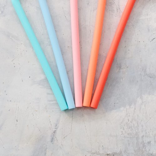 Three Wide Reusable Silicone Straws in teal, pink and coral fanned out