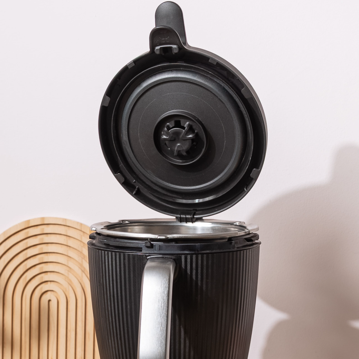 Thermomix TM7 lid standing upright on the bowl, held by the WunderClip